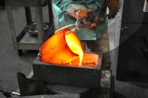 A gold refiner pour liquid gold into a crucible