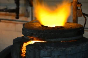 Flames rising from a gold refinery furnace