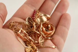 assorted gold jewelry in palm of hand