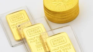 Three Swiss half ounce gold bullion bars and a stack of gold coin bullion