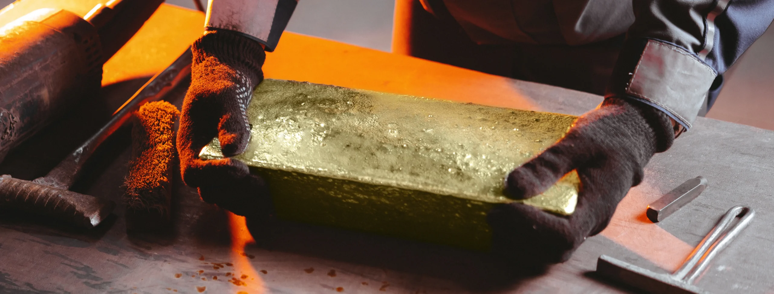 large gold bullion bar being refined