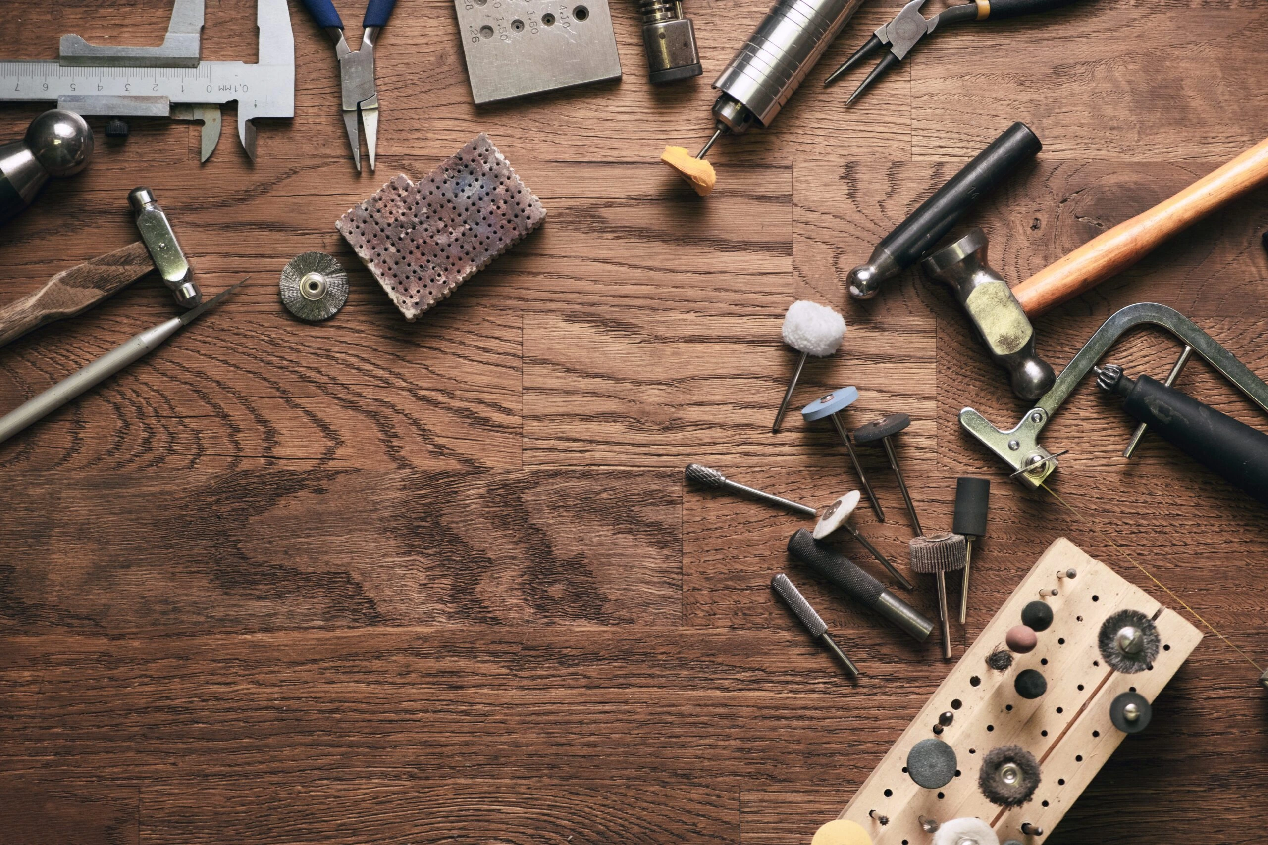 Top view of gold jewelry maker's workbench with tools on table