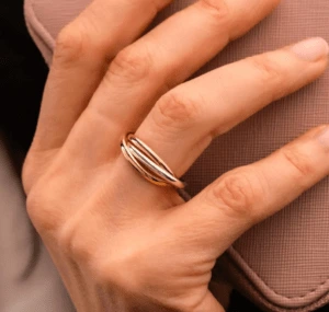 Rose gold spinner ring on ring finger